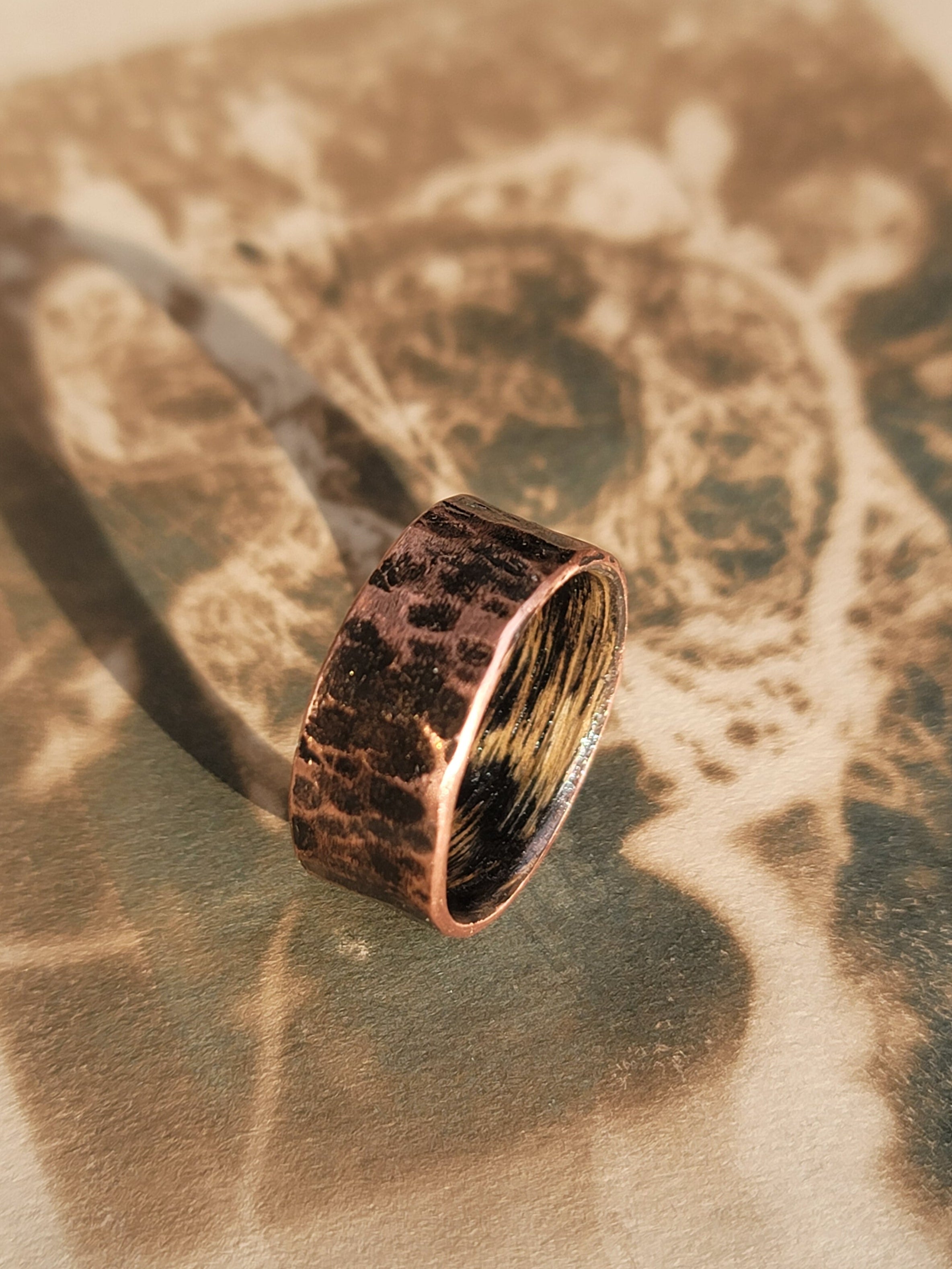 Bronze ring on a textured surface with a blurred background