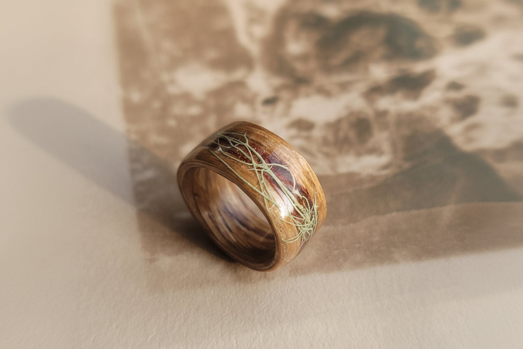 Wooden ring with natural design on a textured surface
