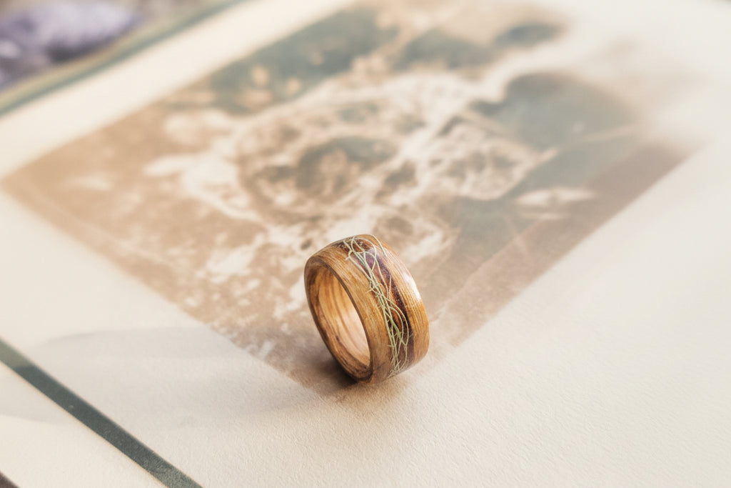 Wooden ring with lichen on a textured surface